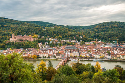 High angle view of townscape by river against sky