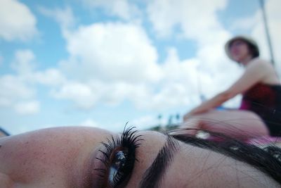 Close-up of woman hand against sky