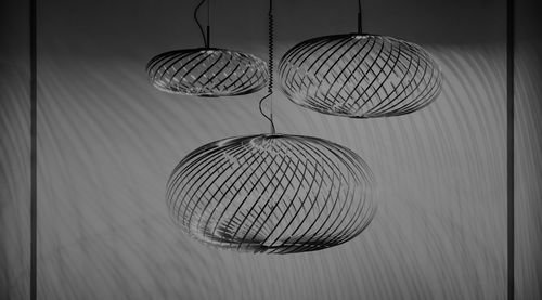 Close-up of pendant lights hanging against wall