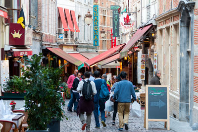 People walking on street against buildings in city