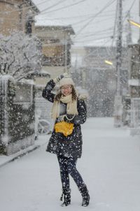 Woman standing on snow covered landscape