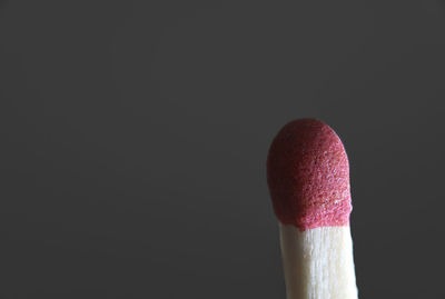 Close-up of red umbrella against black background