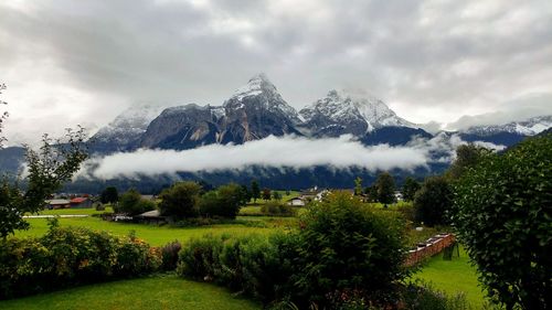 Scenic view of mountains against cloudy sky