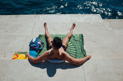 Woman sitting in swimming pool