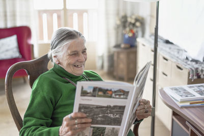 Woman looking at photograph album