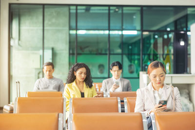 At the airport, a businessperson passes the time. waiting for the plane to take off