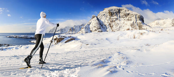 Mature woman skiing on snowcapped mountain