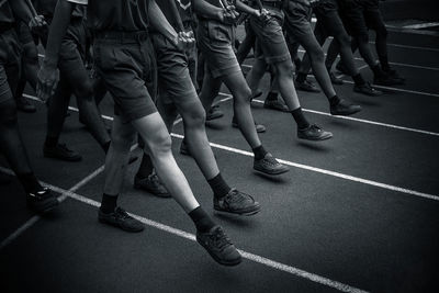 Low section of men marching on street in city
