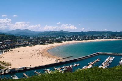 High angle view of sea and cityscape against sky