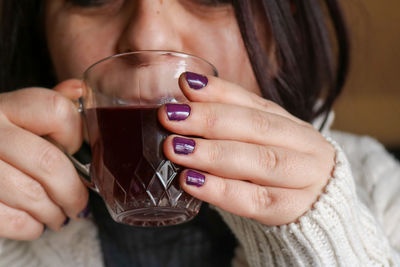 Close-up of woman holding wineglass