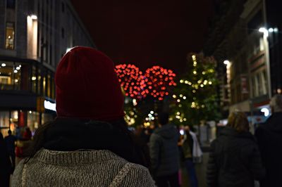 Rear view of couple at illuminated city at night