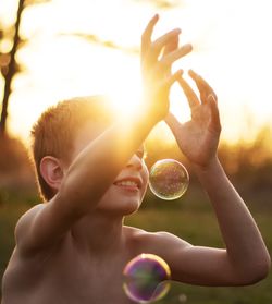 Close-up of boy holding bubbles