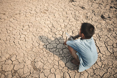 High angle view of child on sand