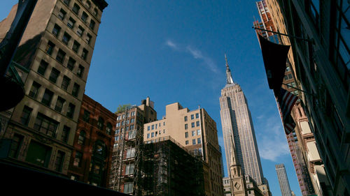 Low angle view of empire state building against sky