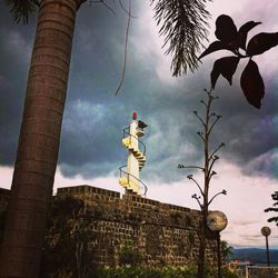 Low angle view of building against cloudy sky