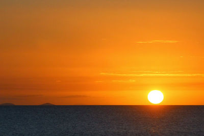 Scenic view of sea against orange sky