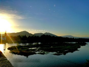 Scenic view of lake at sunset