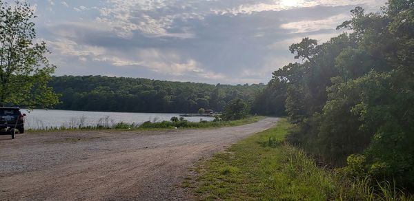 Road by river against sky