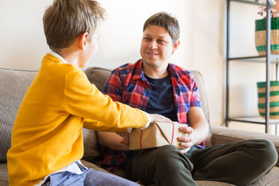 Boys sitting on sofa