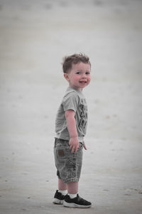 Full length of baby boy standing at beach
