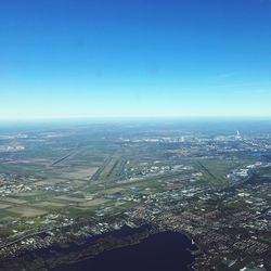 Aerial view of cityscape against clear blue sky