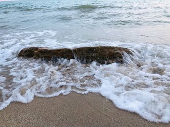 High angle view of waves rushing towards shore