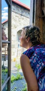 Woman looking through window
