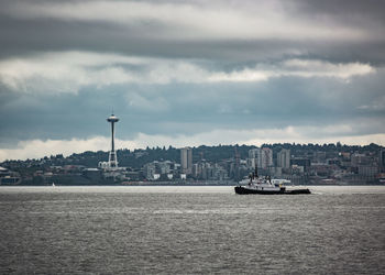 River in city against cloudy sky