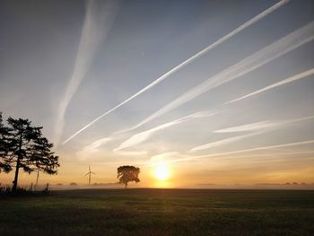 Scenic view of field against sky during sunset