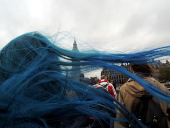 Rear view of woman with fishing net in background