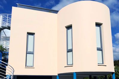 Low angle view of building against clear blue sky