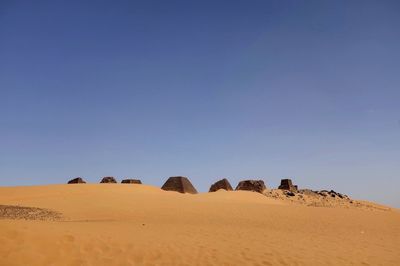 Scenic view of desert against clear blue sky
