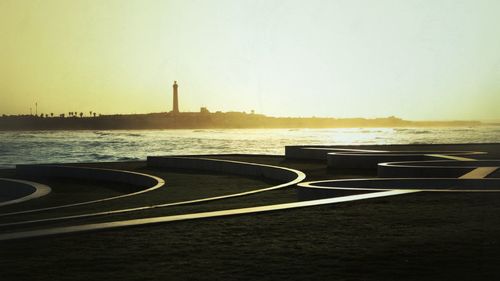 Scenic view of lake by buildings against clear sky