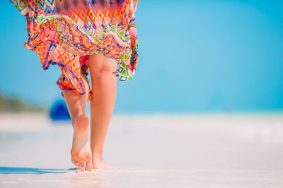 Low section of woman standing on beach