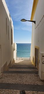 Scenic view of sea by buildings against sky