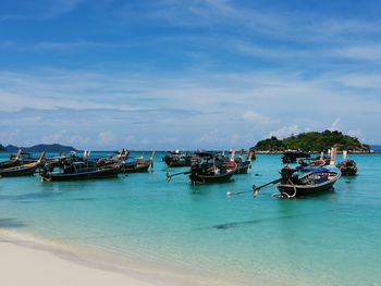 Boats in sea against sky