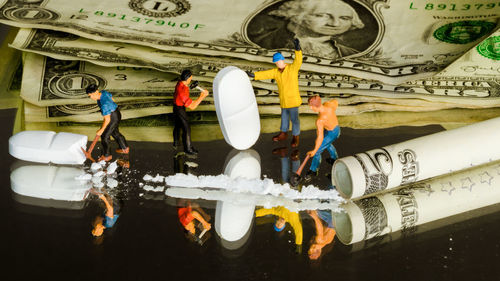 Reflection of people on bridge in water