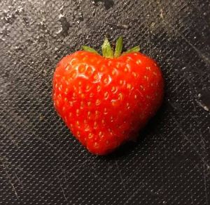 Close-up of strawberry over black background