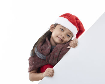 Portrait of cute girl wearing hat against white background