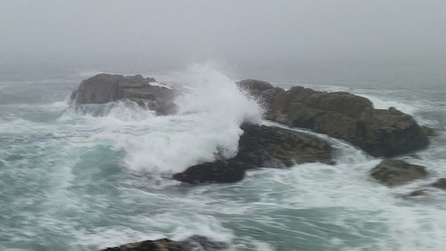 Waves breaking against sea