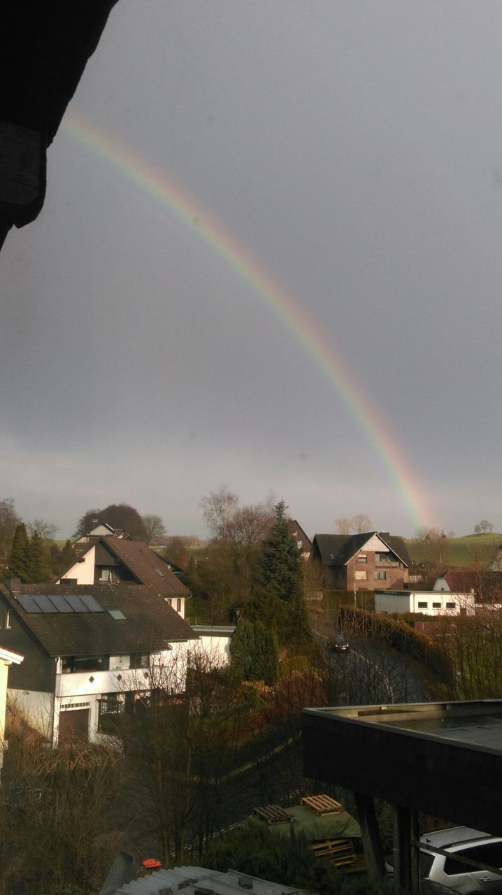 building exterior, architecture, built structure, rainbow, sky, house, tree, residential building, residential structure, cloud - sky, residential district, city, weather, town, road, nature, outdoors, cloudy, no people, roof