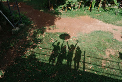 High angle view of people shadow on field