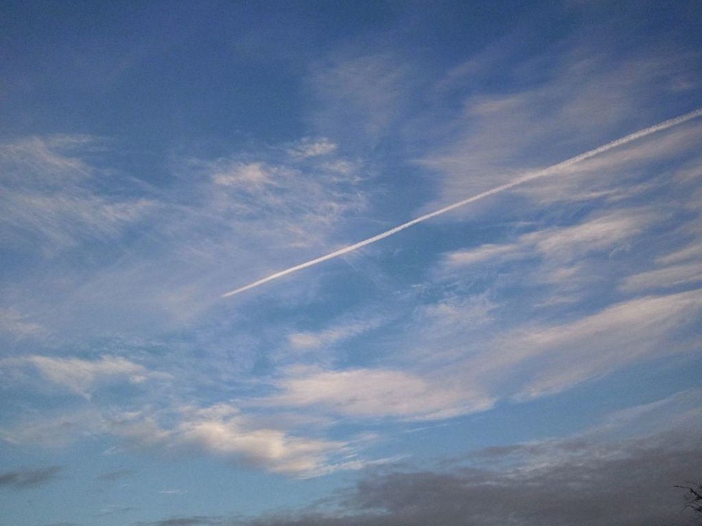 sky, cloud - sky, scenics, blue, beauty in nature, tranquility, tranquil scene, low angle view, nature, cloud, vapor trail, cloudscape, cloudy, idyllic, outdoors, sky only, day, no people, flying, landscape