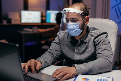 Man wearing mask working at office