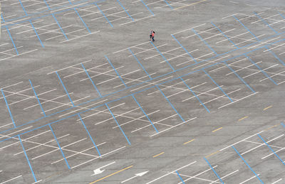 High angle view of man walking on parking area.
