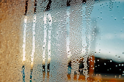 Full frame shot of wet glass window in rainy season