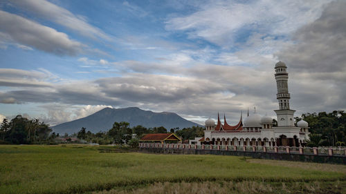 View of temple building against cloudy sky