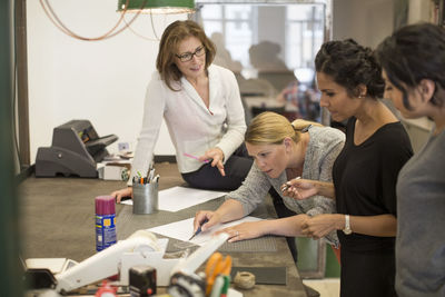 Creative businesswomen preparing plan at table in office