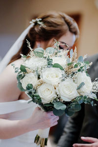 Midsection of woman holding rose bouquet