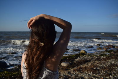 Young woman standing at beach